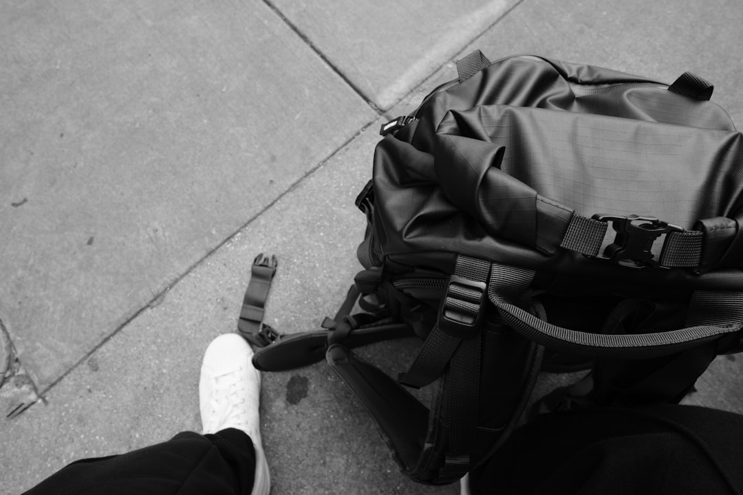 a-black-and-white-photo-of-a-person-with-a-backpack-yaanpq1ujle